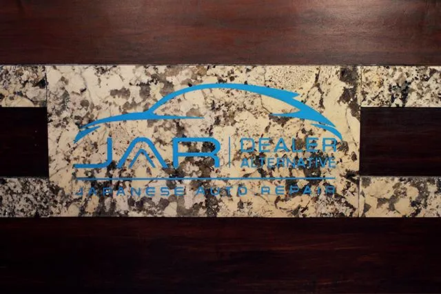 Japanese Auto Repair Logo on Granite