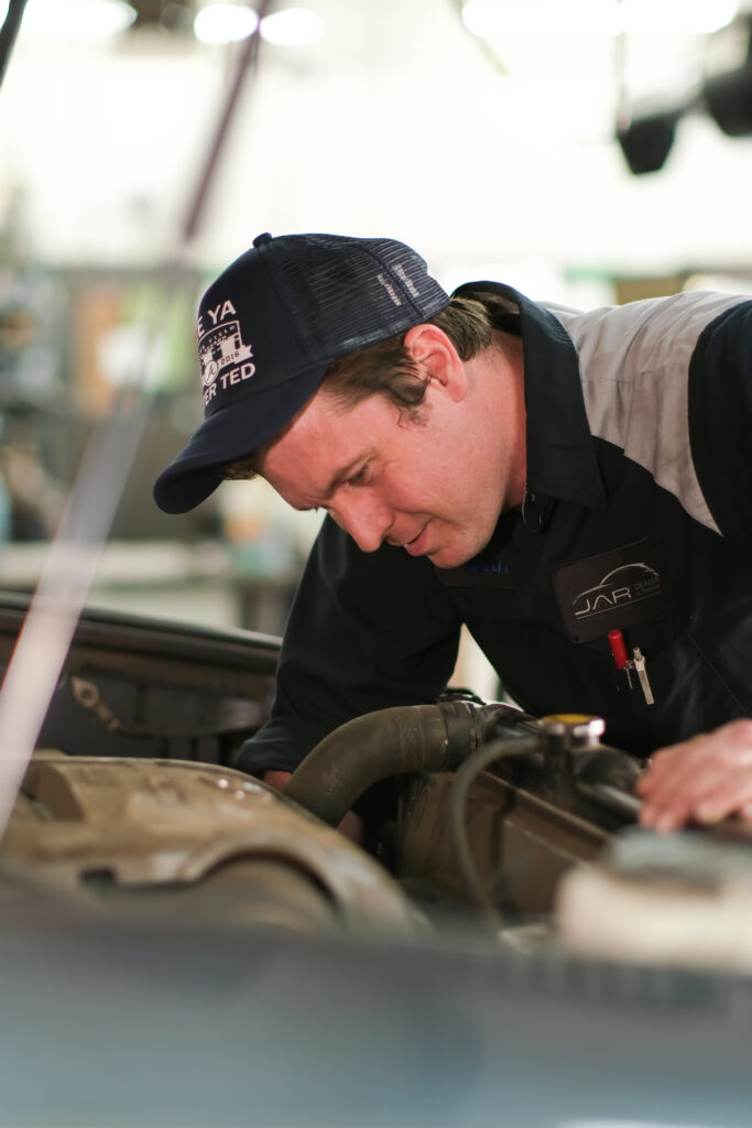 Auto Shop Mechanic Inspecting Vehicle Repair