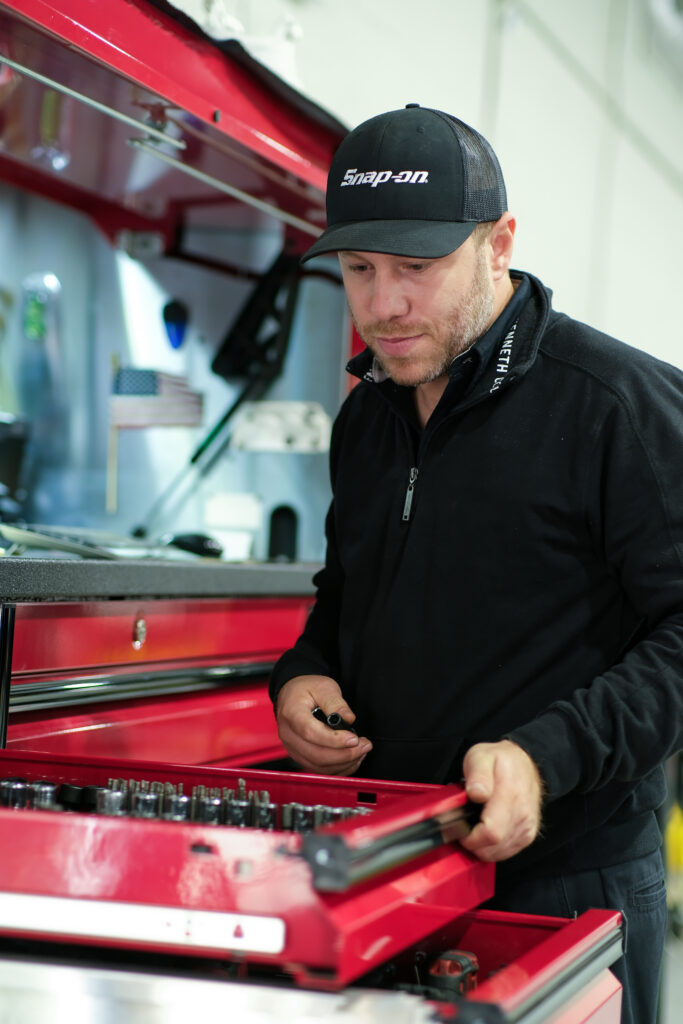 Car Mechanic Looking At Tools