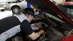 A mechanic at Japanese Auto Repair servicing a vehicle in the shop