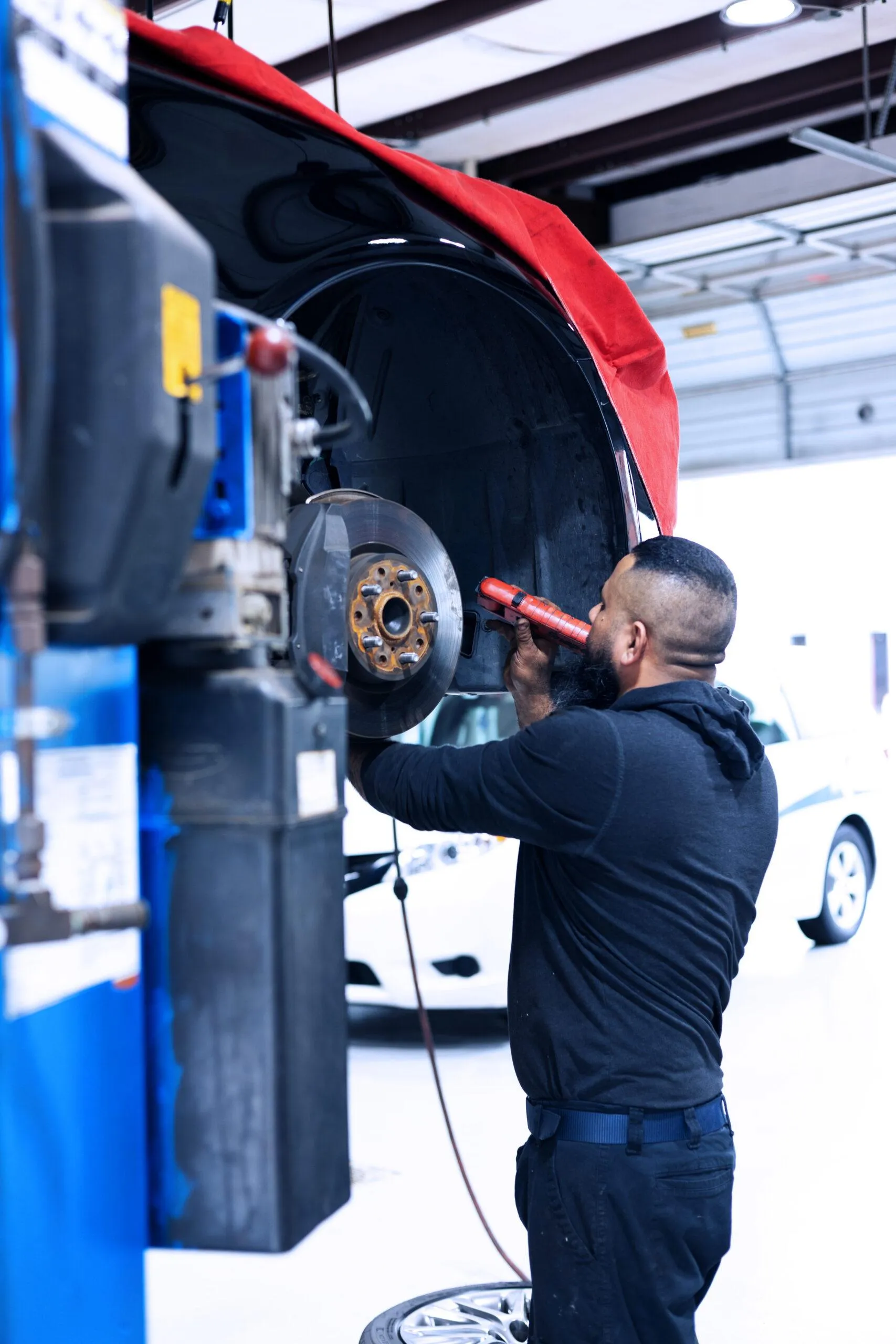 mechanic works on car wheel and tire