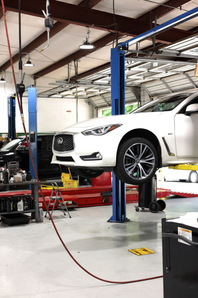 white car getting serviced for wheel noise